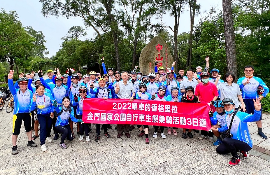 The Director and the riders take a happy photo before departure